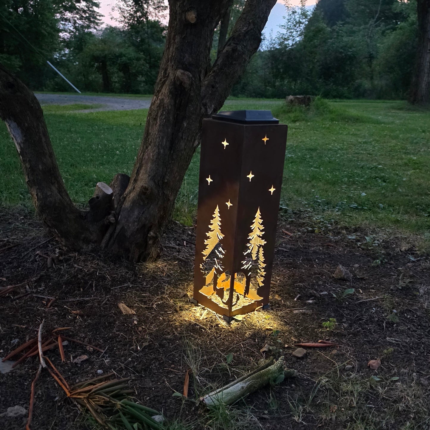 Rustic bear solar pillar outdoors at sunset showing a warm glow