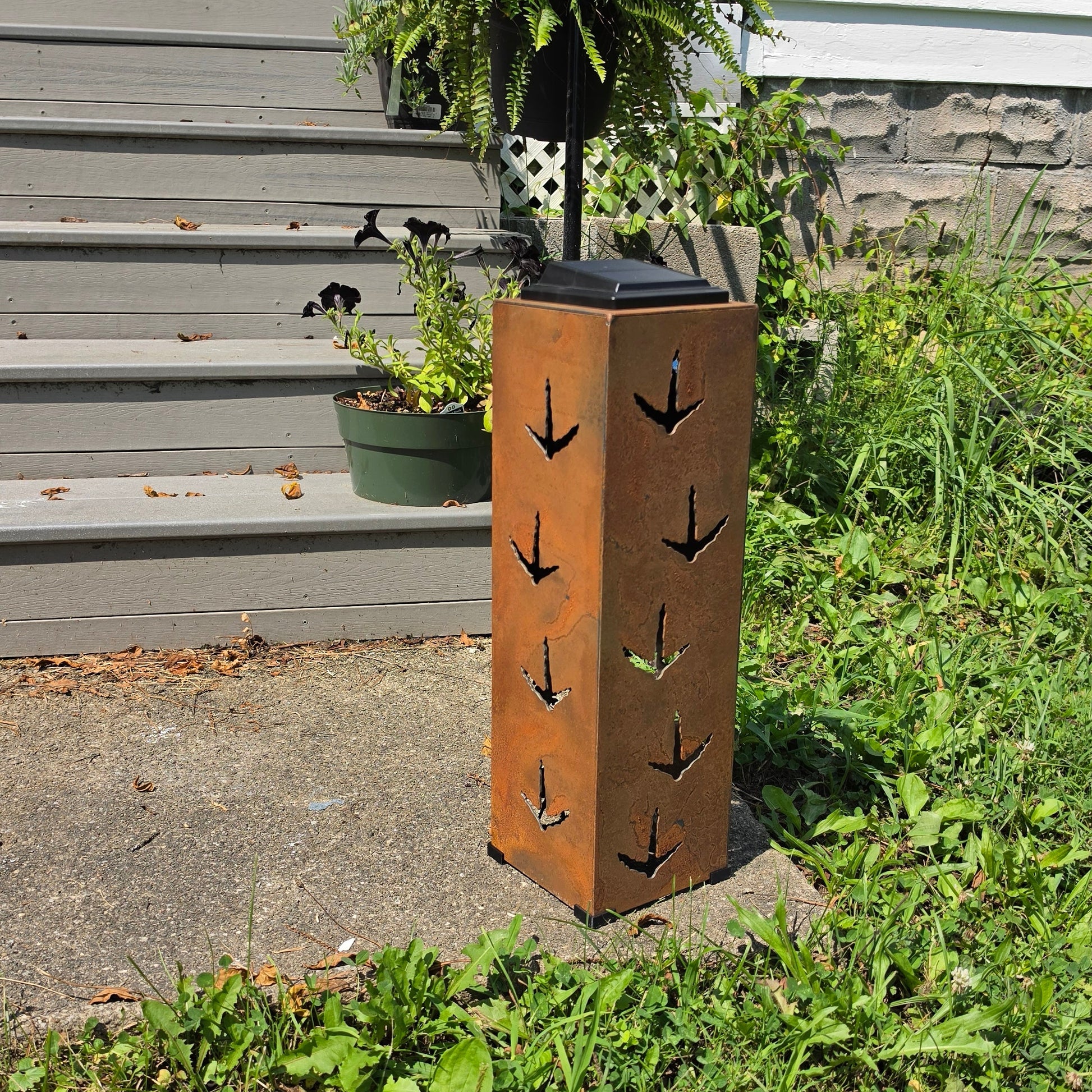 Rustic Turkey solar pillar on front patio showing turkey prints
