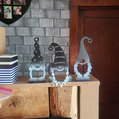 metal gnomes sitting on shelf