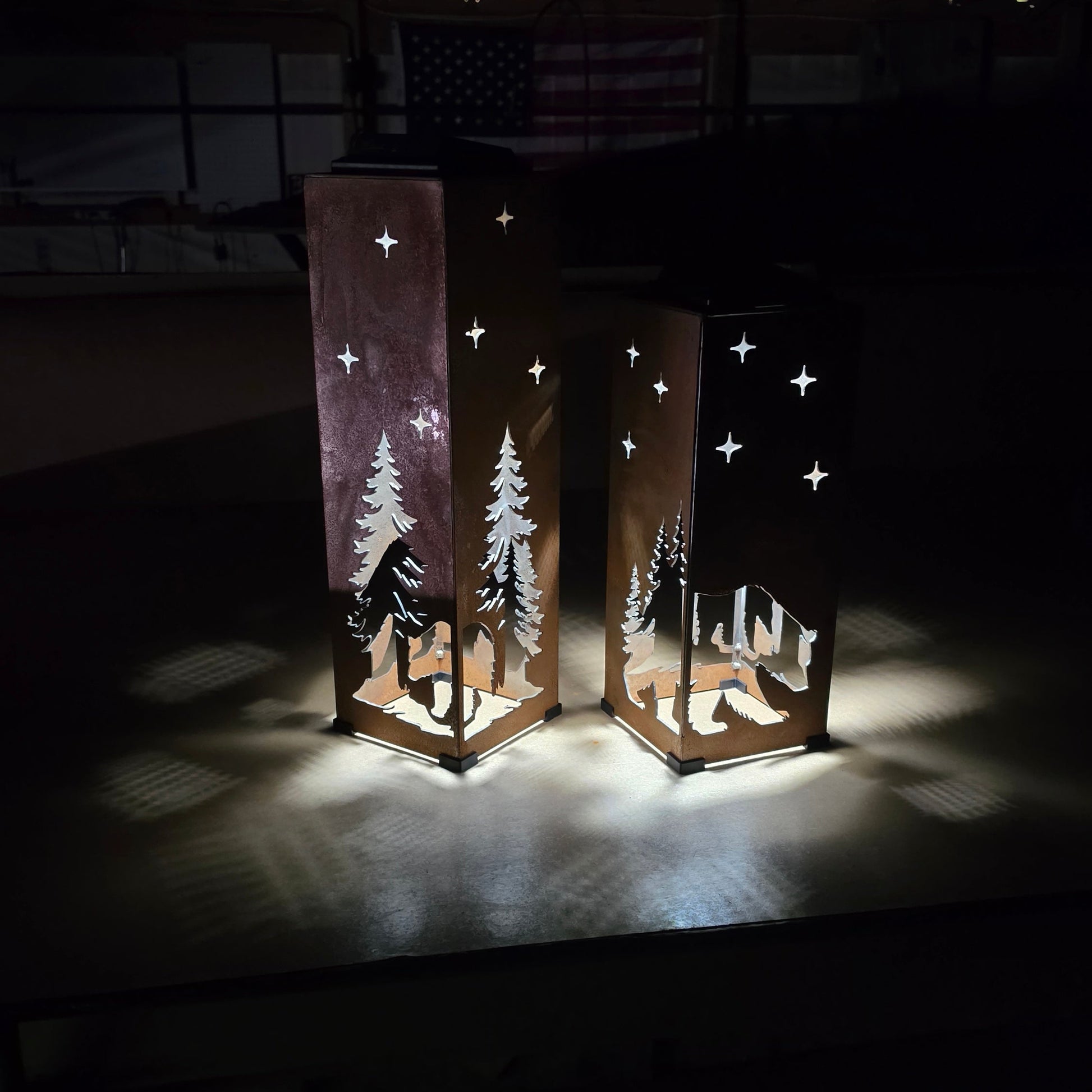 two rustic metal solar pillars with a Bear theme