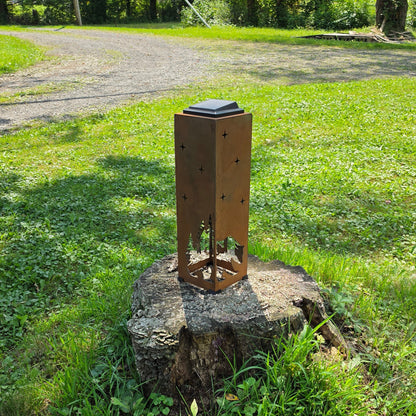 Rustic Metal Bear themed solar pillar on a stump outdoors showing the reverse side
