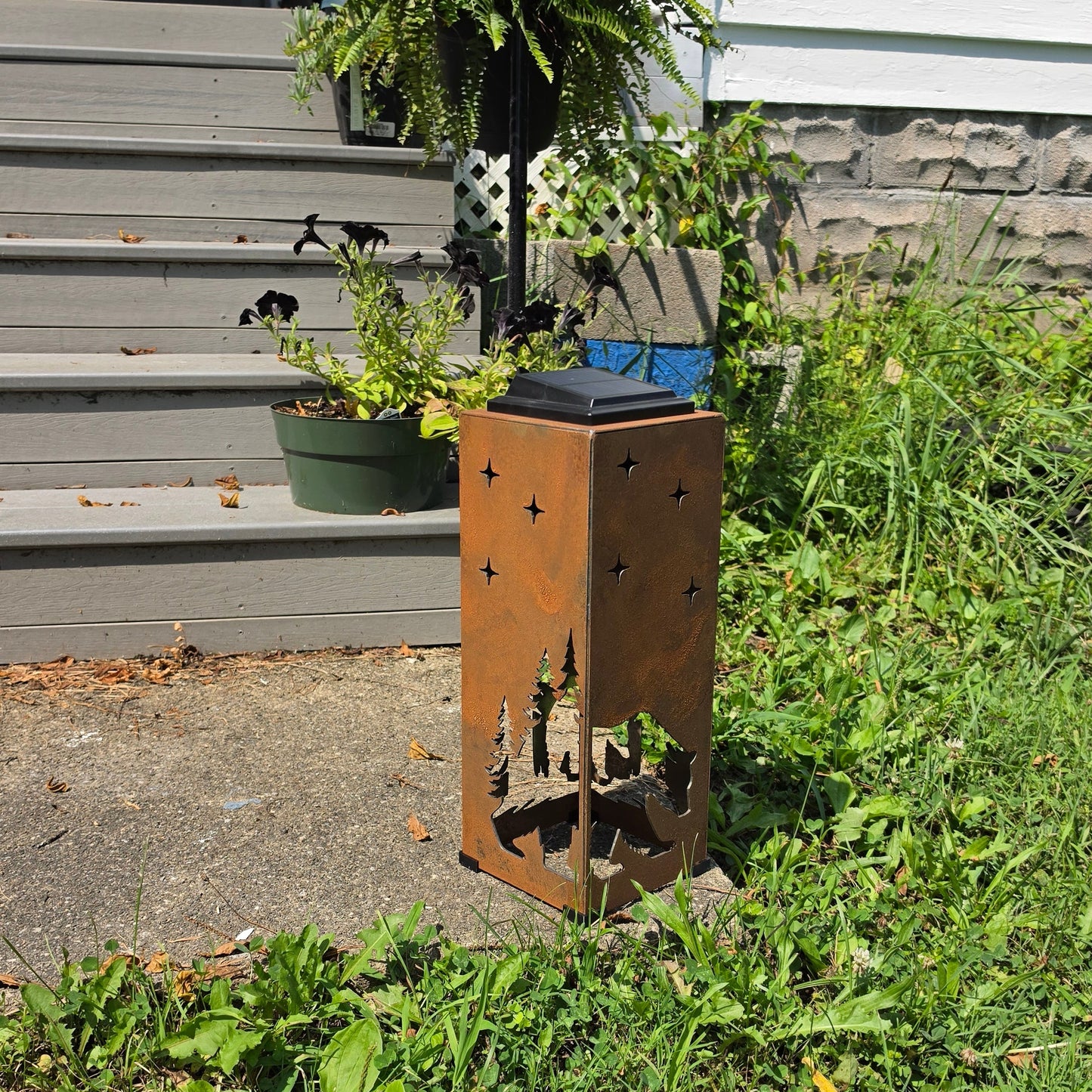 Rustic metal Bear themed solar pillar on front patio showing opposite side