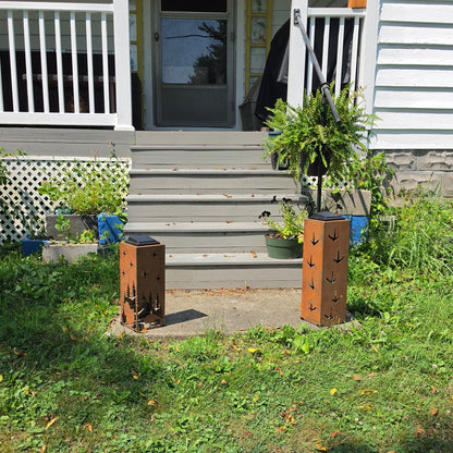 Two turkey themed rustic solar pillars outdoors on front patio
