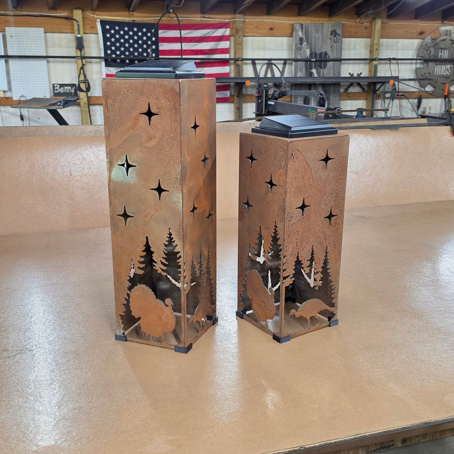 two rustic metal turkey themed solar pillars in the shop