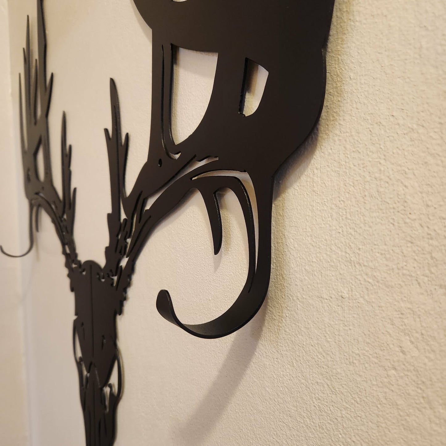 Deer skull bow rack showing the hooks