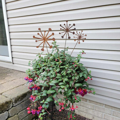 rustic metal dandelion plant stakes in a set of three