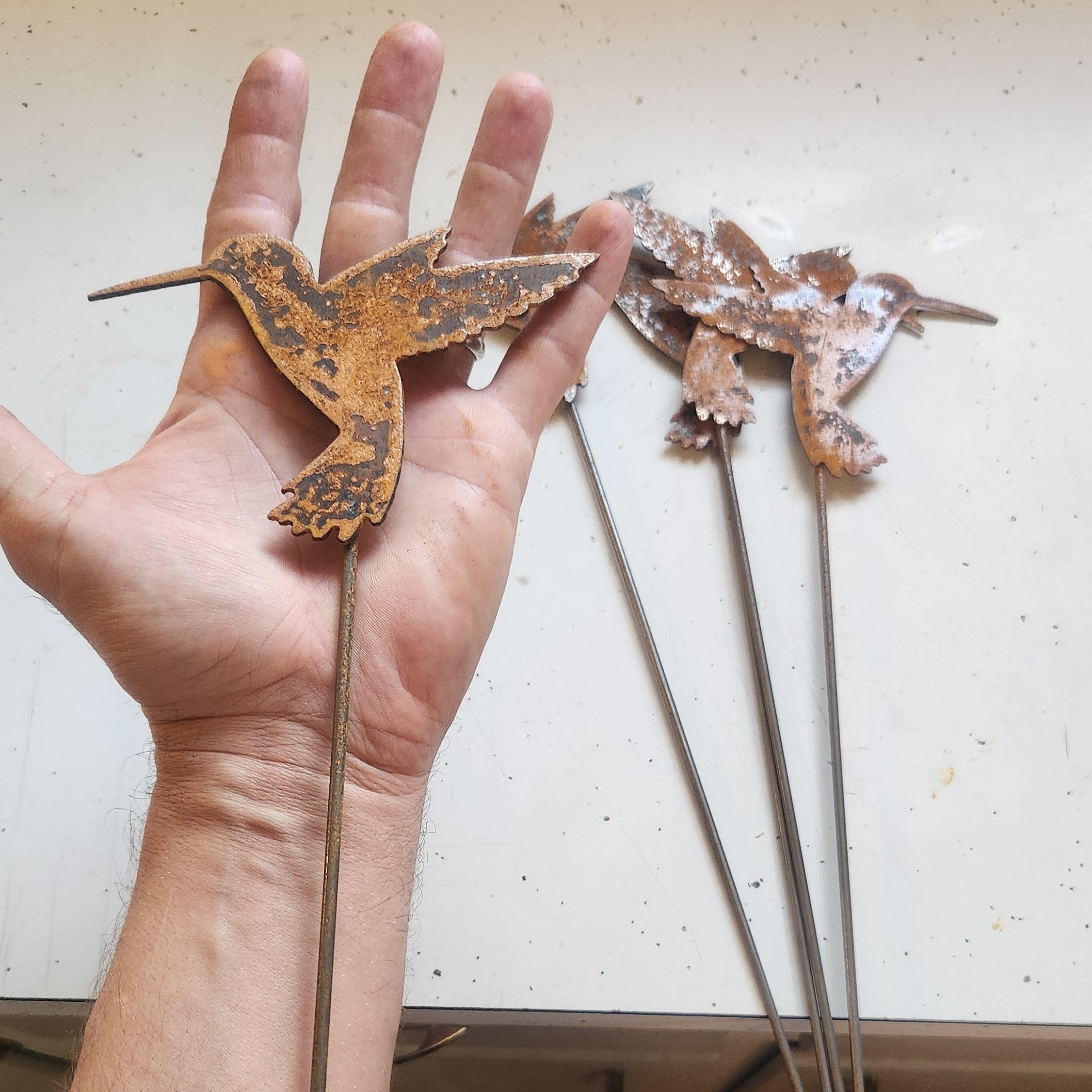Rustic metal hummingbird 4 inch plant stake size comparison.