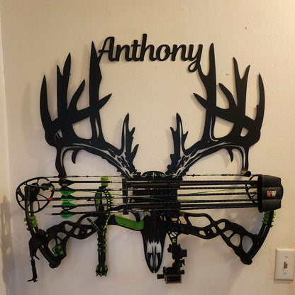 Decorative wall art with deer antlers and bow, personalized with 'Anthony'.