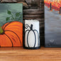 Metal candle wrap resembling a pumpkin