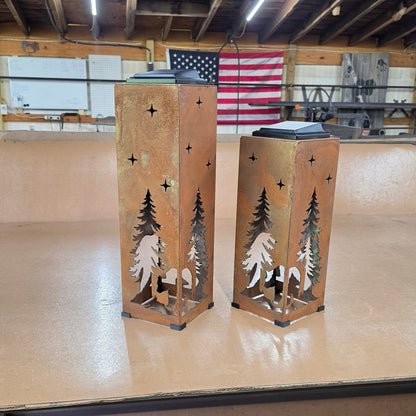 Two rustic Bear themed solar pillars in a shop setting
