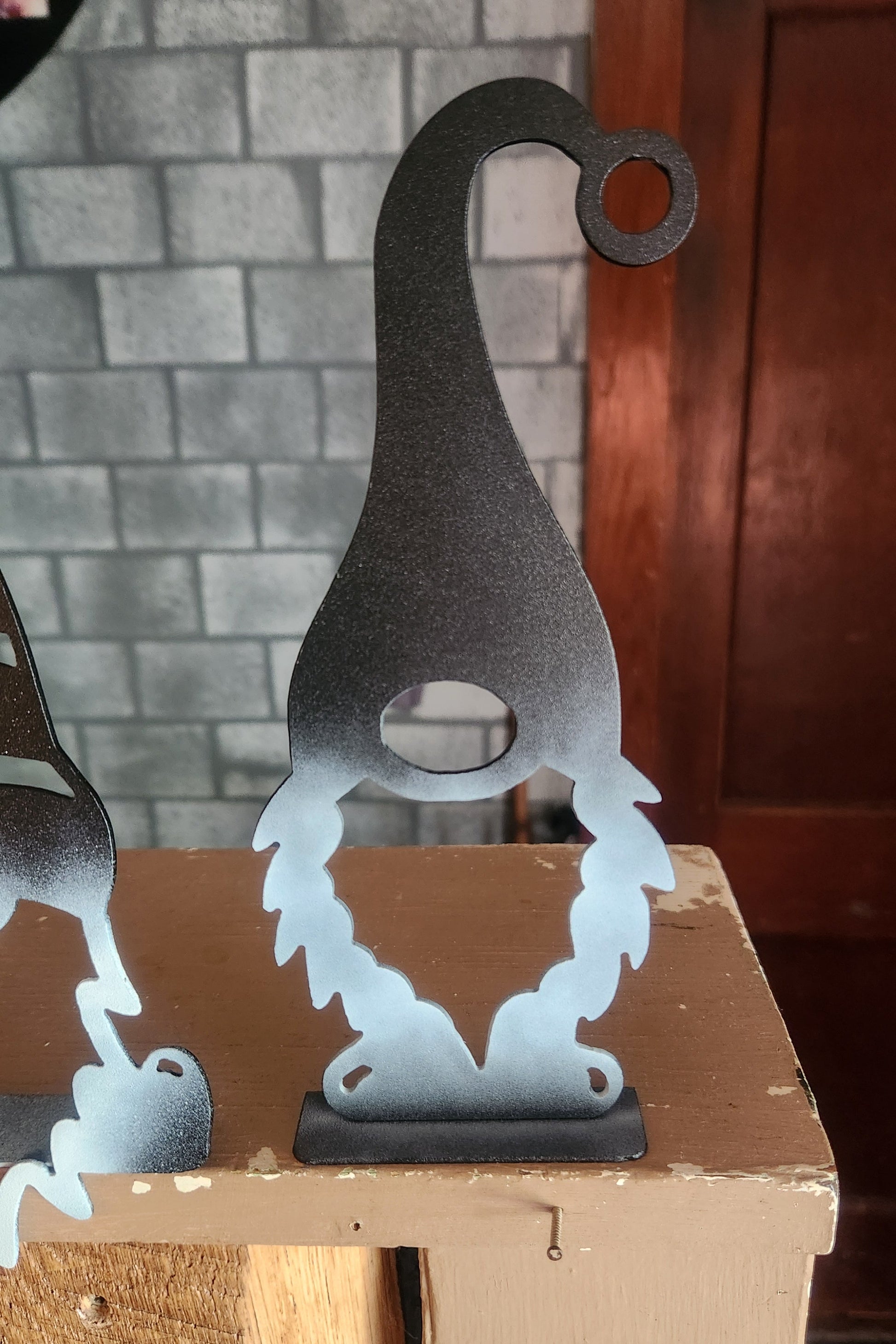 Metal gnome standing on shelf
