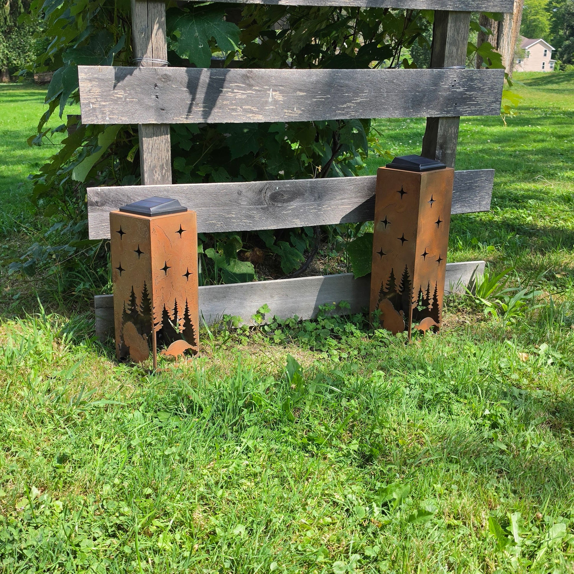 Two Turkey Solar Pillars front facing outdoors in front of grape vines