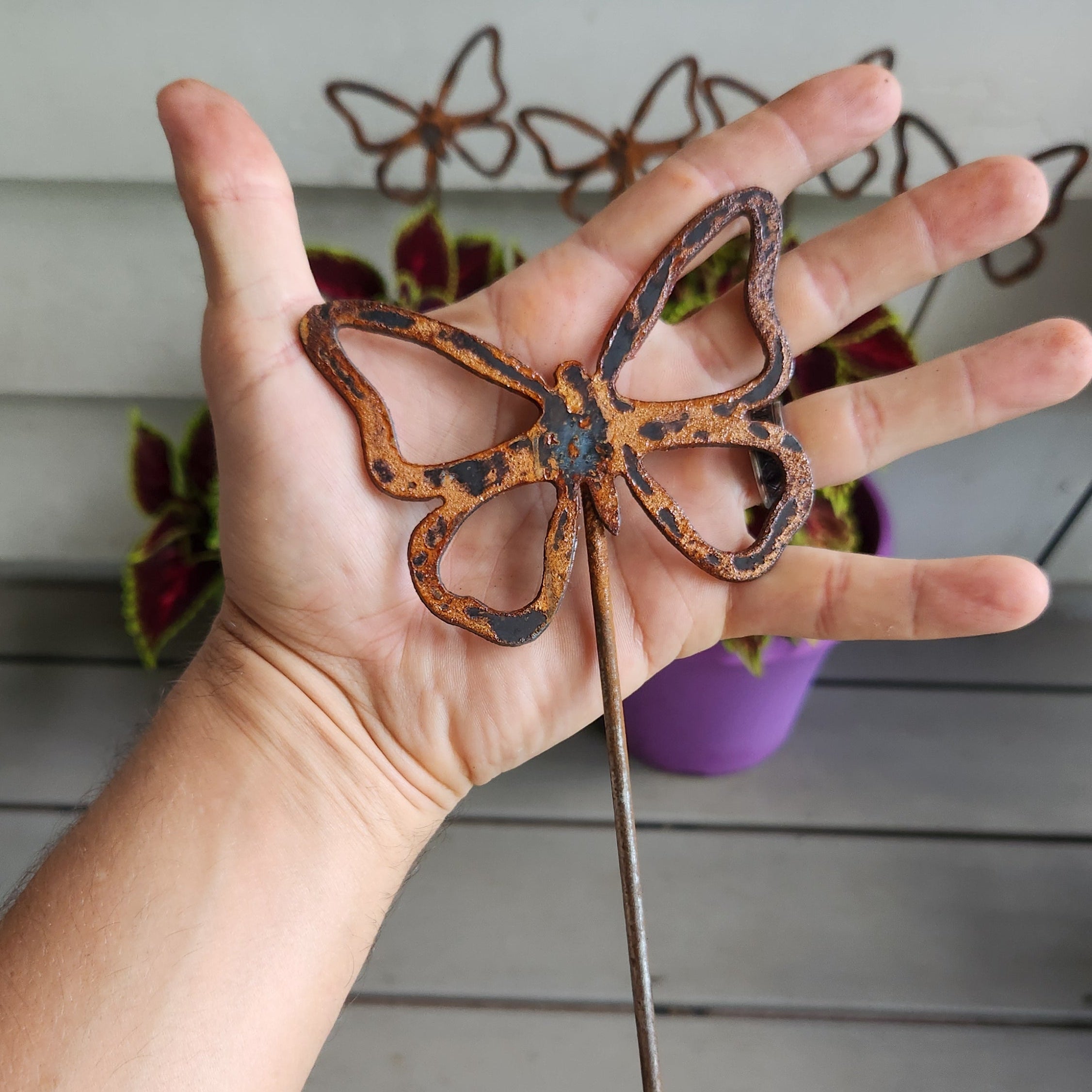 Rustic metal butterfly plant stake 4in size comparison.