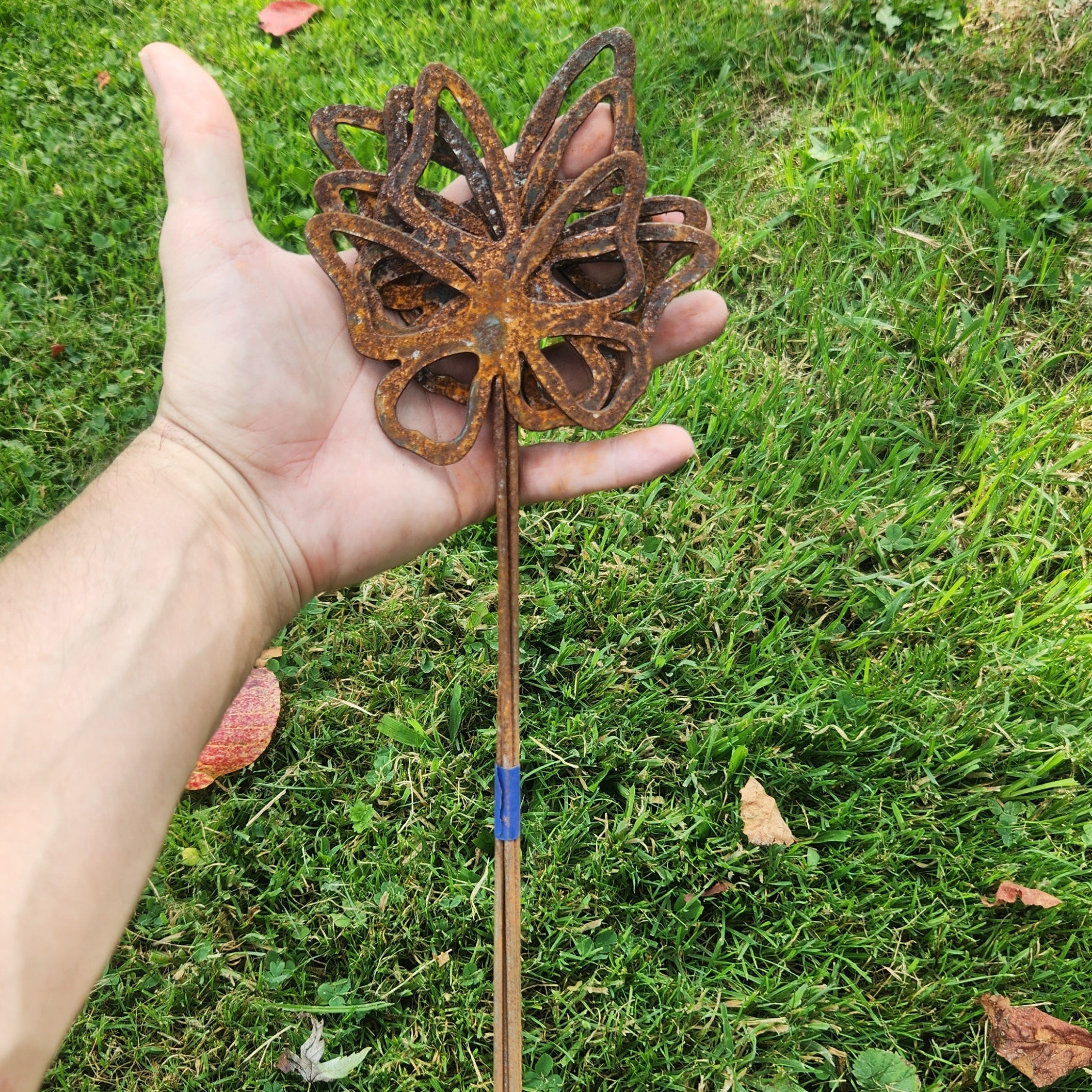 Rustic metal butterfly plant stakes in a bundle.