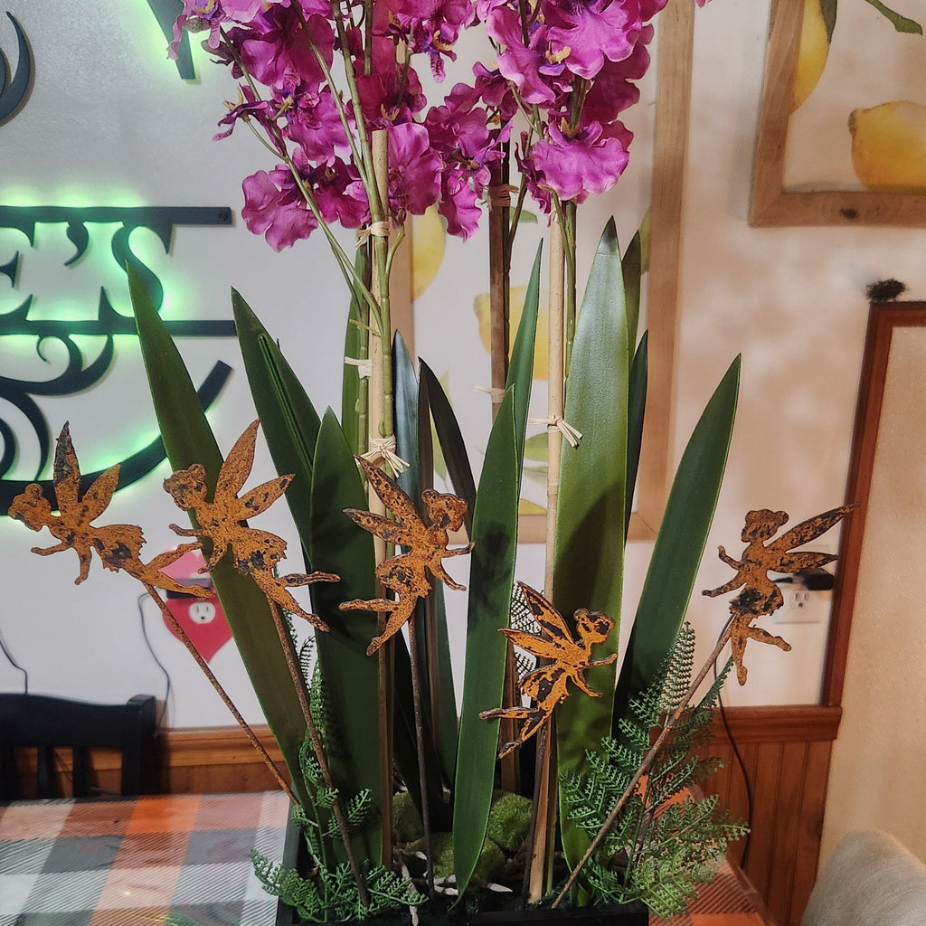 Fairy rustic metal plant stakes in potted plant.