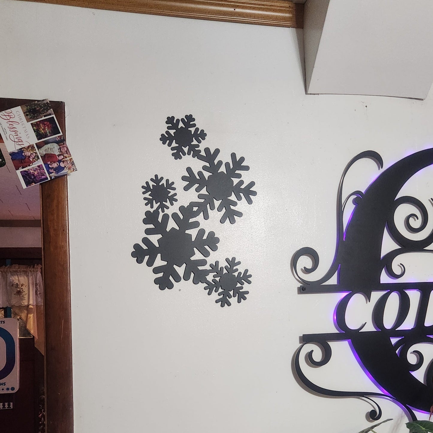 Elegant powder coated snowflakes in a falling pattern on a kitchen wall