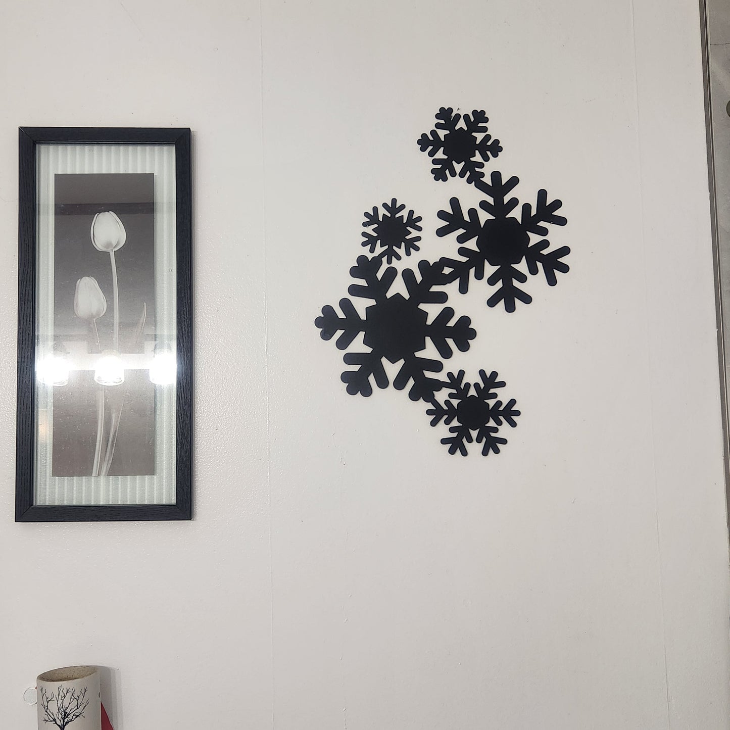 elegant snowflakes in a falling pattern on a white wall