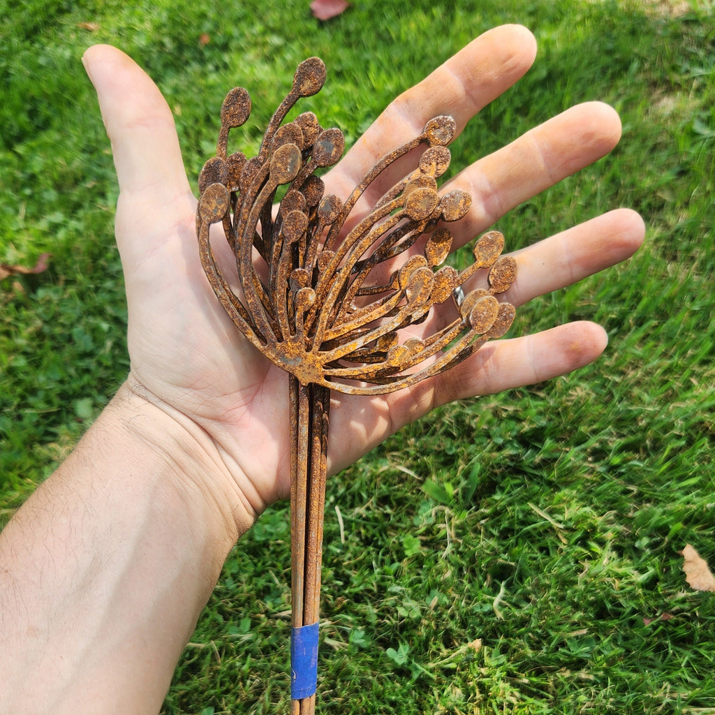 Rustic metal wind swept dandelion plant stake bundle.